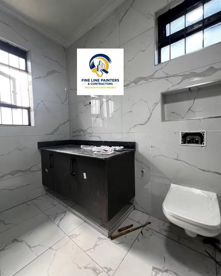 Marble tiled bathroom with dark vanity unit